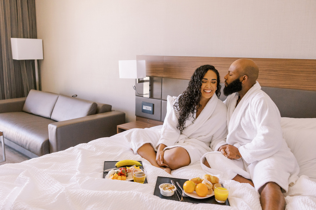 Staycation Couple Having Breakfast in Bed